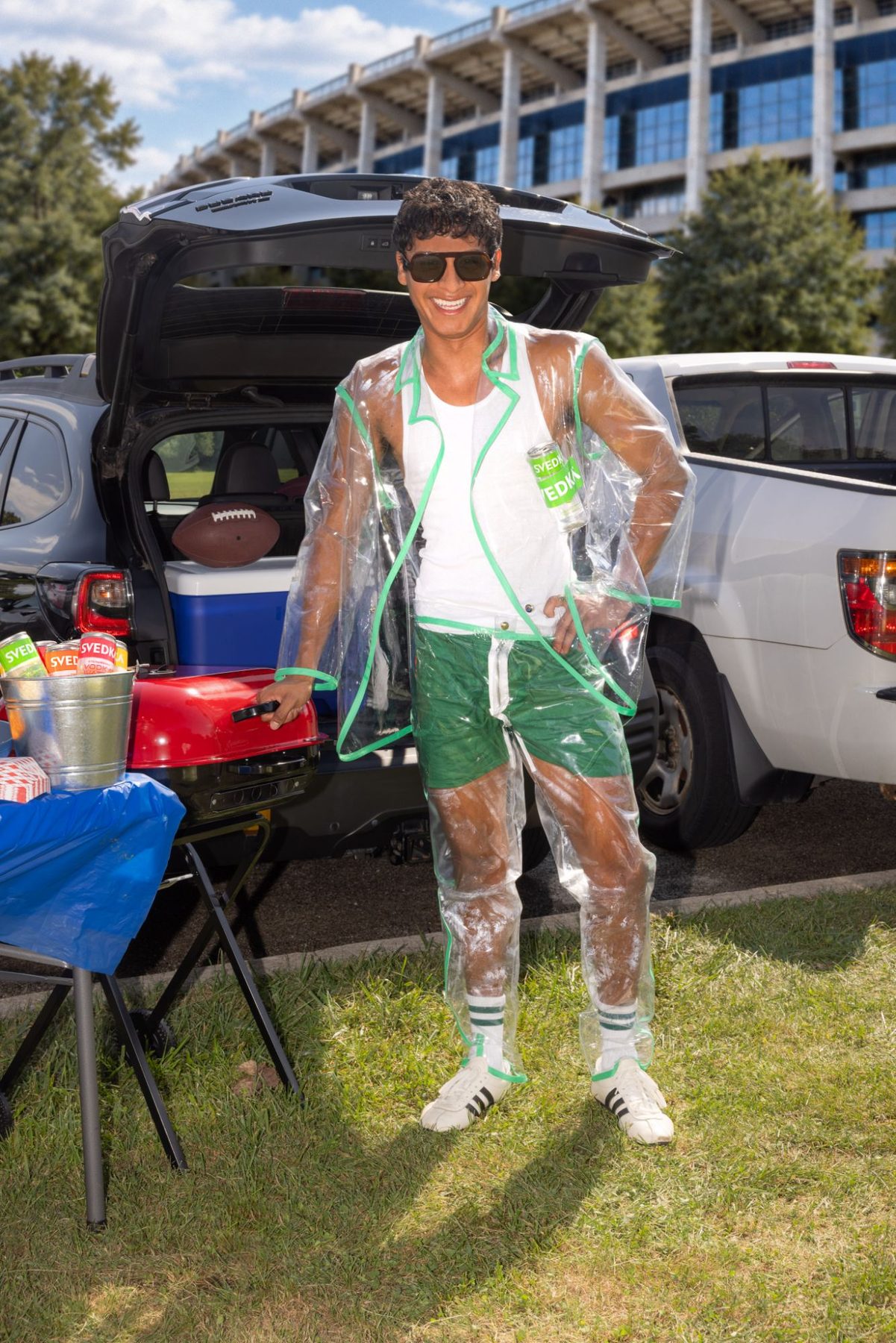 A tailgater in the green-trimmed Lime Transparent Suit with a can of SVEDKA Lime Vodka Water in the chest-pocket can holder