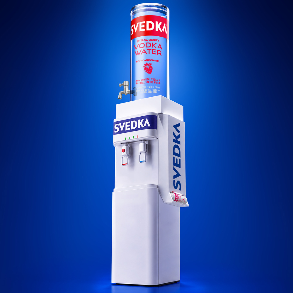 Full-height front view of the five-foot SVEDKA Water Cooler topped with the giant transparent SVEDKA Vodka Water can